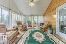 Sunroom with vaulted ceiling and extensive window line - 9503 54 Street Nw, Edmonton, AB 