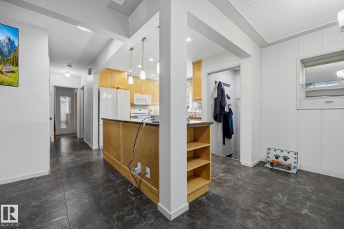 Open-concept layout featuring dark-toned flooring - 9503 54 Street Nw, Edmonton, AB - Indoor