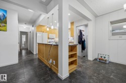 Open-concept layout featuring dark-toned flooring - 