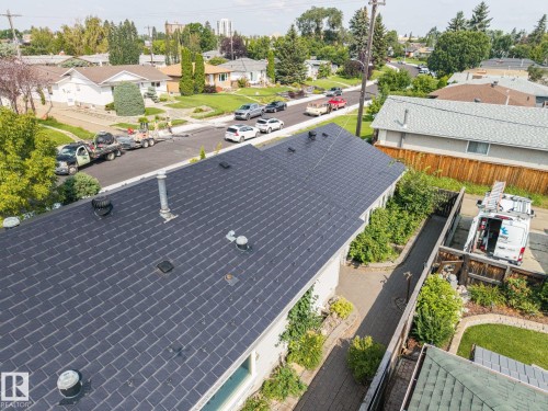 New architectural asphalt shingle roof with multiple roof penetrations and ventilation features - 9503 54 Street Nw, Edmonton, AB - Outdoor
