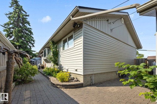 Modern home featuring horizontal fiber cement siding, pitched roofline with substantial overhang, and large multi-pane windows providing natural light - 9503 54 Street Nw, Edmonton, AB - Outdoor With Exterior
