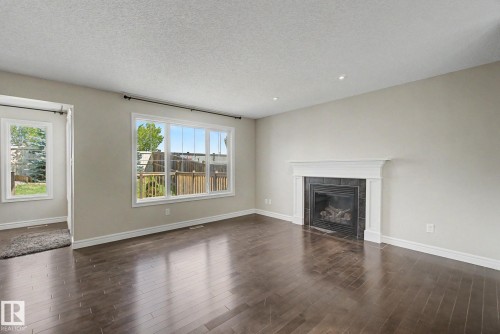 15868 10 Avenue Sw, Edmonton, AB - Indoor Photo Showing Living Room With Fireplace