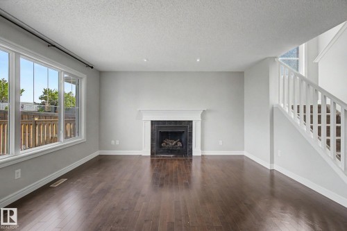 15868 10 Avenue Sw, Edmonton, AB - Indoor Photo Showing Living Room With Fireplace