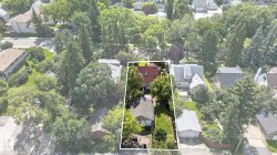 Property situated on a lot with mature trees and a detached garage - 