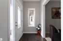 Entryway featuring dark wood-finish flooring, white trim, and a frosted glass-panel door - 1312 26 Avenue Nw, Edmonton, AB  - Indoor Photo Showing Other Room 