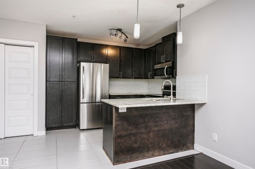 #229 5151 Windermere Bv Sw, Edmonton, AB - Indoor Photo Showing Kitchen With Stainless Steel Kitchen
