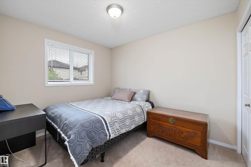 Room featuring neutral-toned walls, white trim, and a textured ceiling - 3344 24 Avenue Nw, Edmonton, AB - Indoor Photo Showing Bedroom