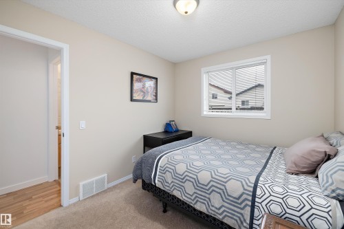 Carpeted room featuring neutral wall tones, a single window with white trim, and a ceiling-mounted light fixture - 3344 24 Avenue Nw, Edmonton, AB - Indoor Photo Showing Bedroom