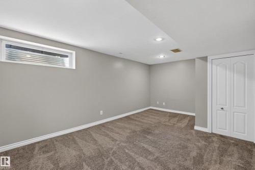 Recessed lighting, neutral gray wall paint, white trim, textured carpet flooring, bi-fold closet doors - #25 200 Erin Ridge Dr, St. Albert, AB - Indoor