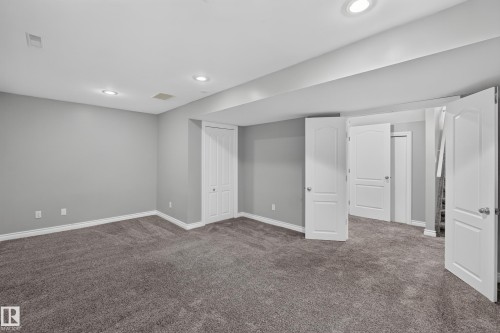 Recessed lighting, gray carpeting, gray painted walls, and white interior doors - #25 200 Erin Ridge Dr, St. Albert, AB - Indoor Photo Showing Other Room