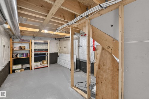 Unfinished basement with exposed wood joists, concrete flooring, and visible ductwork - #25 200 Erin Ridge Dr, St. Albert, AB - Indoor Photo Showing Basement
