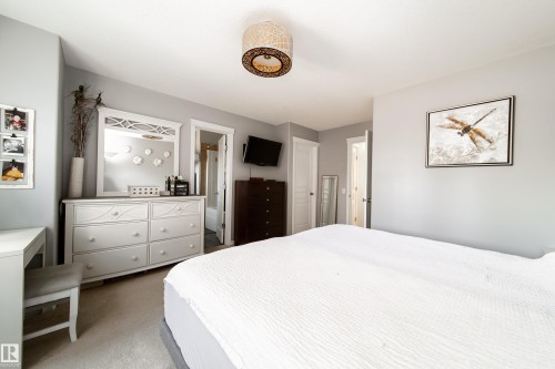 Wall-to-wall carpeting and a ceiling-mounted light fixture - 7239 21 Avenue Sw, Edmonton, AB - Indoor Photo Showing Bedroom