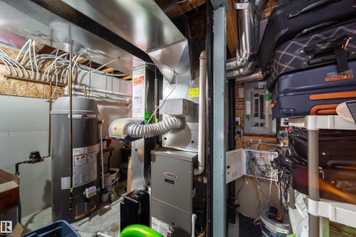 Utility space featuring a water heater, furnace, and electrical panel - 7239 21 Avenue Sw, Edmonton, AB - Indoor Photo Showing Basement
