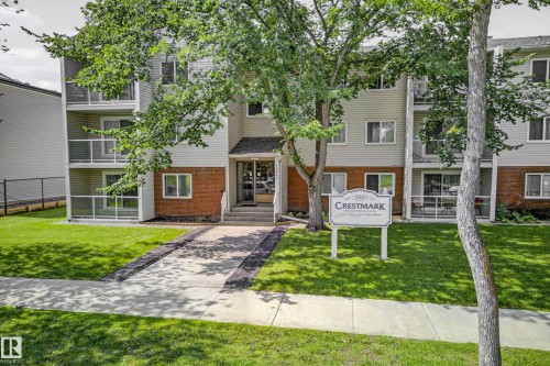 Multi-story residential building with light-colored siding and brick accents - #206 10842 107 St Nw, Edmonton, AB - Outdoor
