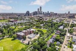 Aerial perspective showcasing a residential neighborhood with a prominent cityscape backdrop - 