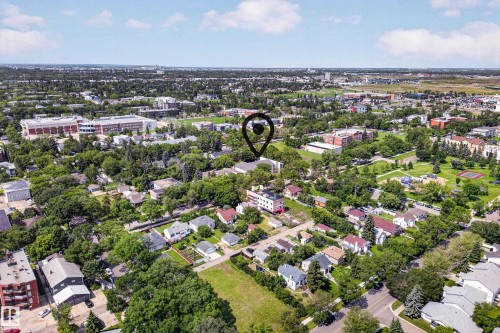 Aerial perspective showcasing a residential area amidst mature trees, with several multi-story buildings and green spaces visible in the surrounding neighborhood - #206 10842 107 St Nw, Edmonton, AB - Outdoor With View