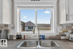 Stainless steel double basin sink with a gooseneck faucet - 