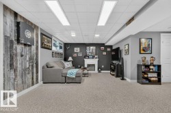 Finished basement featuring recessed lighting and a drop ceiling - 