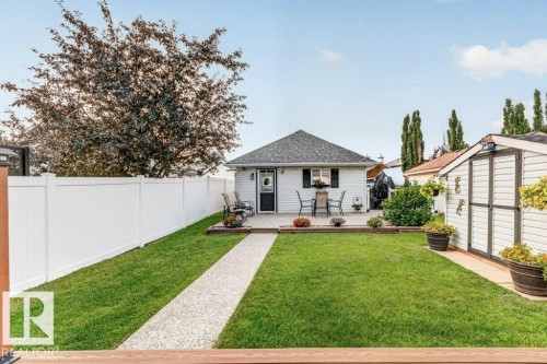Manicured lawn with a gravel pathway leading to a rear patio - 5322 Terwillegar Boulevard Nw, Edmonton, AB - Outdoor