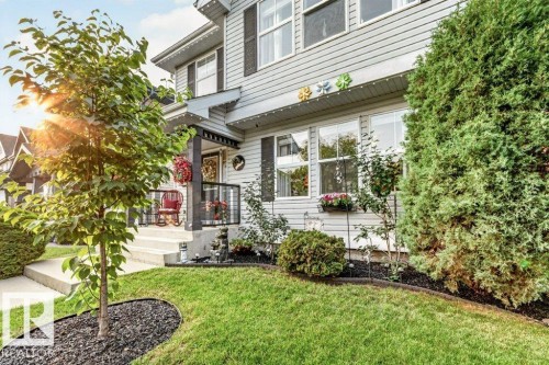 Two-story siding exterior with contrasting black shutters - 5322 Terwillegar Boulevard Nw, Edmonton, AB - Outdoor