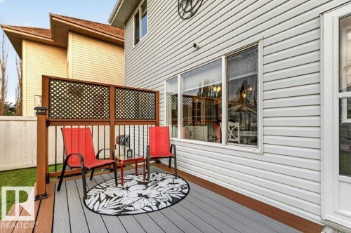 Multi-level deck featuring composite decking, wood-finish railing with black balusters, and privacy lattice - 5322 Terwillegar Boulevard Nw, Edmonton, AB - Outdoor With Deck Patio Veranda With Exterior