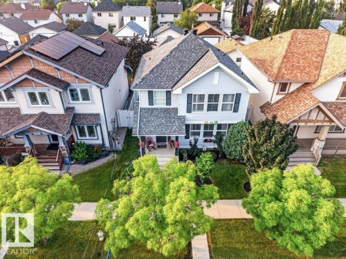 Two-story residence featuring light blue siding with dark shutters, a front-facing gable, and a gray shingle roof - 5322 Terwillegar Boulevard Nw, Edmonton, AB - Outdoor With Facade