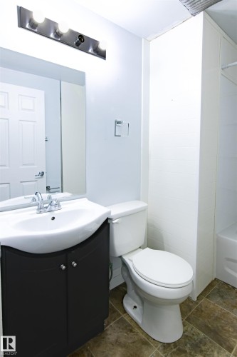 Bathroom with vanity and bathtub / shower combination - 11029 95 Street Nw, Edmonton, AB - Indoor Photo Showing Bathroom