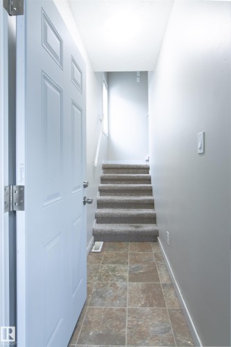 Staircase featuring stone finish flooring and baseboards - 11029 95 Street Nw, Edmonton, AB - Indoor Photo Showing Other Room