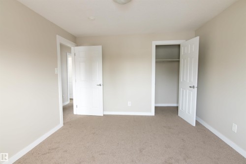 Unfurnished bedroom featuring light colored carpet and a closet - 11029 95 Street Nw, Edmonton, AB - Indoor Photo Showing Other Room