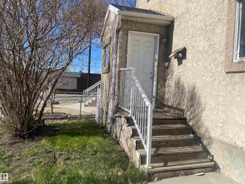 Entryway featuring a white paneled door, exterior light fixture, and mailbox - 11029 95 Street Nw, Edmonton, AB - Outdoor