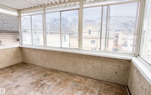 Unfurnished sunroom featuring stone finish floors - 11029 95 Street Nw, Edmonton, AB - Indoor Photo Showing Other Room