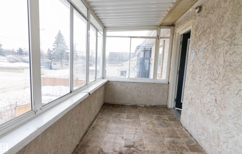 Unfurnished sunroom with stone finish flooring - 11029 95 Street Nw, Edmonton, AB - Indoor Photo Showing Other Room