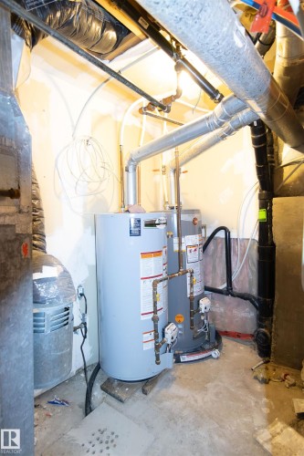 Utilities with water heater - 11029 95 Street Nw, Edmonton, AB - Indoor Photo Showing Basement