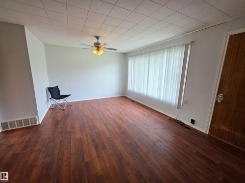Expansive kitchen with ample cabinetry, a built-in sink, and a large window - Rural St. Paul County, AB 