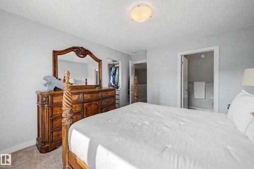 Neutral wall paint, carpet flooring, flush mount ceiling light, and an open doorway - 1783 Keene Crescent Sw, Edmonton, AB - Indoor Photo Showing Bedroom