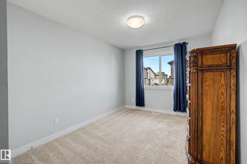 Recessed ceiling light fixture, neutral carpeting, and a window with a white frame - 1783 Keene Crescent Sw, Edmonton, AB - Indoor Photo Showing Other Room