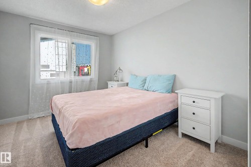 Light gray wall paint, textured carpeting, white trim, and a flush mount ceiling light - 1783 Keene Crescent Sw, Edmonton, AB - Indoor Photo Showing Bedroom