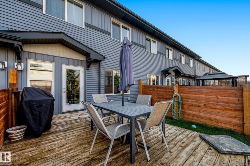 Private wood-plank deck with wood fencing and direct access to the interior through a glass-paneled door - 1783 Keene Crescent Sw, Edmonton, AB - Outdoor With Deck Patio Veranda With Exterior