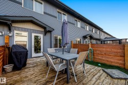 Private wood-plank deck with wood fencing and direct access to the interior through a glass-paneled door - 