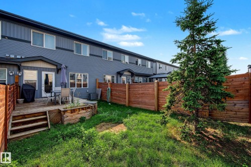 Private backyard featuring a wood deck, wood privacy fence, and mature tree - 1783 Keene Crescent Sw, Edmonton, AB - Outdoor With Deck Patio Veranda With Exterior