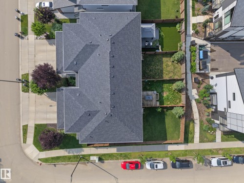 Asphalt shingle roofing, paved driveway, landscaped front yard, and fenced backyard with a deck - 1783 Keene Crescent Sw, Edmonton, AB - 