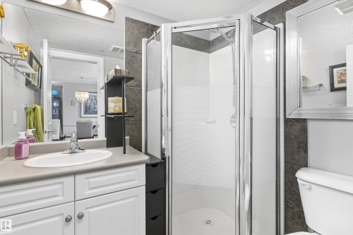White vanity with panel detailing, single basin sink, and a chrome faucet - #305A 6 Spruce Ridge Dr, Spruce Grove, AB - Indoor Photo Showing Bathroom