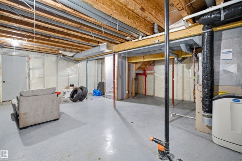 Unfinished basement with exposed ceiling joists and concrete flooring - 714 87 Street Sw, Edmonton, AB - Indoor Photo Showing Basement