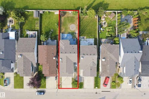 Aerial perspective highlighting a residential property with a paved driveway and a two-story structure featuring a gabled roof - 714 87 Street Sw, Edmonton, AB - 