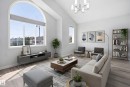 Vaulted ceiling living area featuring a large arched window, wood-finish flooring, and a contemporary chandelier - 714 87 Street Sw, Edmonton, AB  - Indoor Photo Showing Living Room 