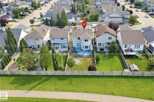 Two-story residence featuring a blue deck, private fenced yard with mature trees, and an exterior storage shed - 714 87 Street Sw, Edmonton, AB - Outdoor With View