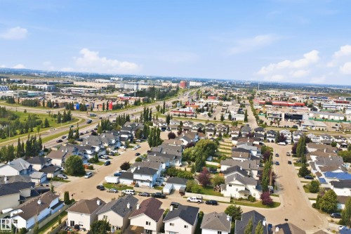 Aerial perspective showcasing a residential neighborhood with varied home styles and rooflines, surrounded by mature trees - 714 87 Street Sw, Edmonton, AB - Outdoor With View
