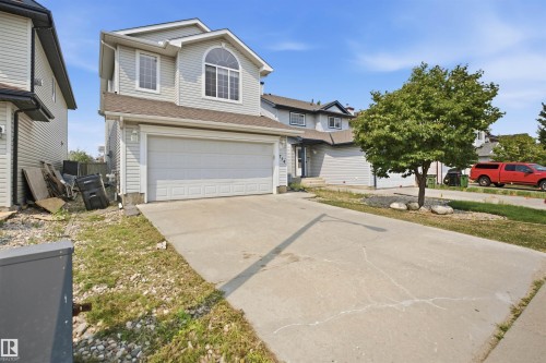 Two-story residence featuring light gray siding, an attached two-car garage, and a concrete driveway - 714 87 Street Sw, Edmonton, AB - Outdoor With Facade