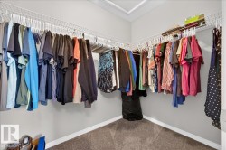 Corner closet with wire shelving system and carpet flooring - 