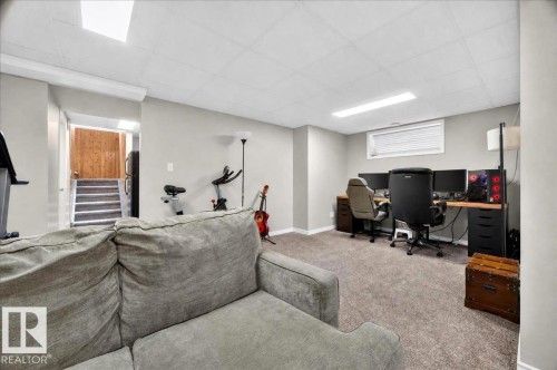 Finished Basement Recreation Space featuring plush seating, carpeted flooring, recessed ceiling lighting, and dedicated zones for entertainment and workspace - 887 Oakland Boulevard, Devon, AB - Indoor Photo Showing Basement